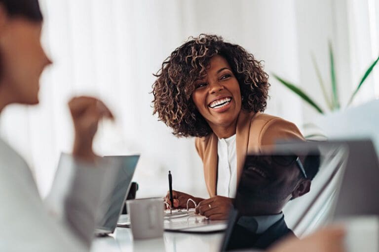 Portrait of cheerful businesswoman smiling at the meeting