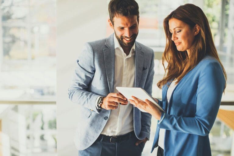 Young business couple working on tablet