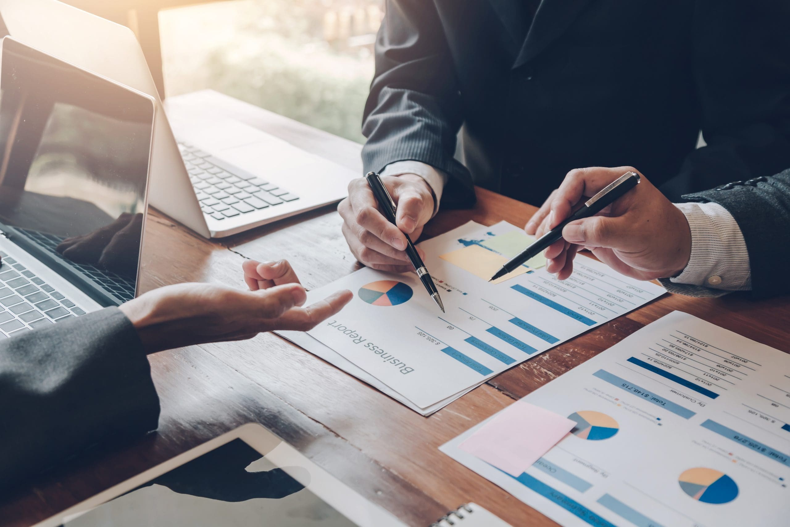 Teamwork process. Business people pointing at business document