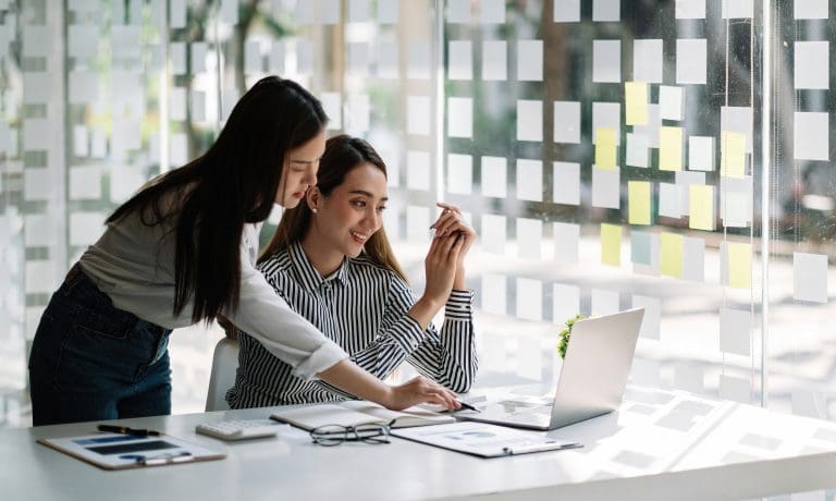 Businessman and business woman discuss to working with using laptop computer and for searching information stock market chart for trading to Make a profit. Planning and Investment concept.