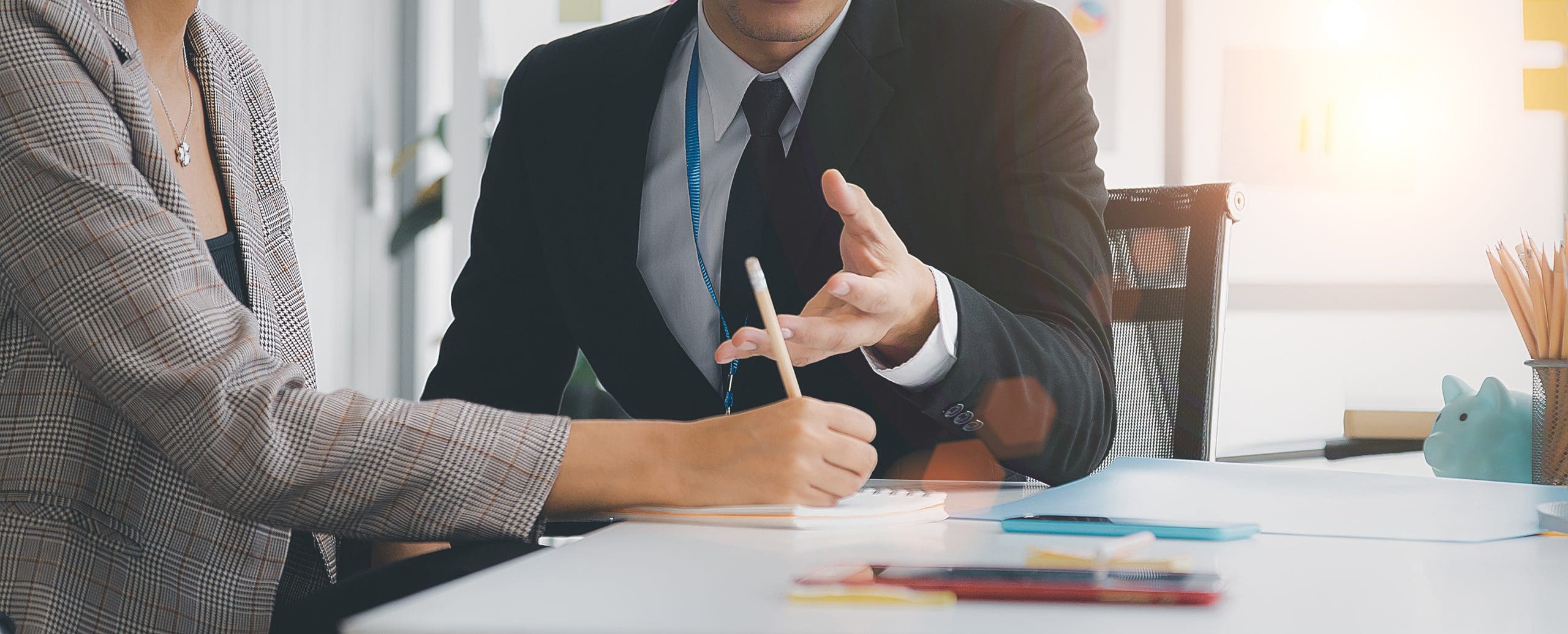 A young business boss is assigning a young secretary to document
