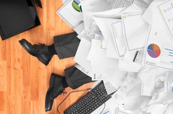 Man buried under a bunch of papers