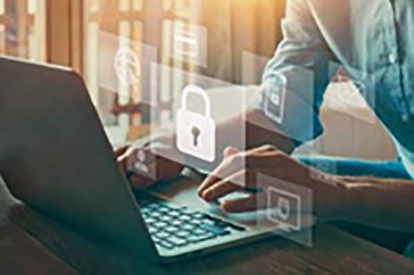 Man typing on laptop with translucent icons of a lock, data and security around him