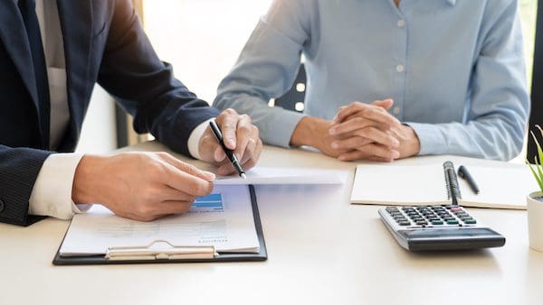 wealth management concept, business man and team analyzing financial statement for planning financial customer case in office.