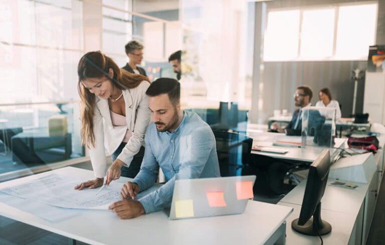 Group of coworkers working together on business project in modern office
