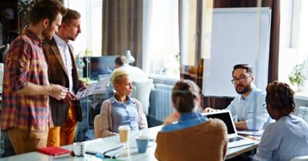 Board meeting with two men presenting to everyone