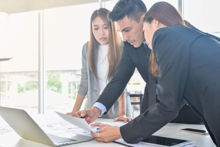 Financial report analysis and reviewing concept :CFO or chief financial officer sees financial summary reports with his secretary and discusses about future growth and improvements.