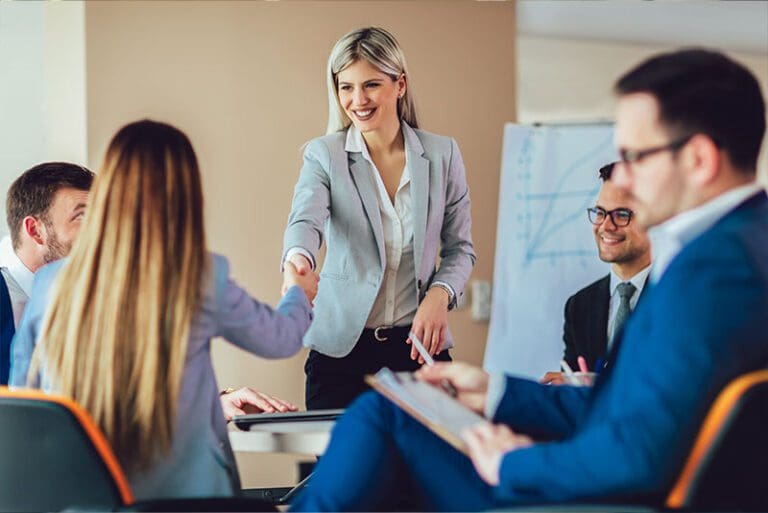 Business shaking hand with a client in office