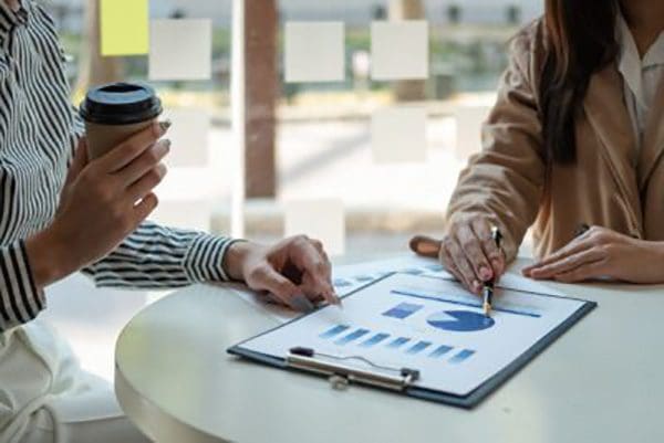 Close up business people meeting in office. hands hold documents with financial statistic discussion analysis report data the charts graphs Finance Teamwork successful Workplace strategy Concept.