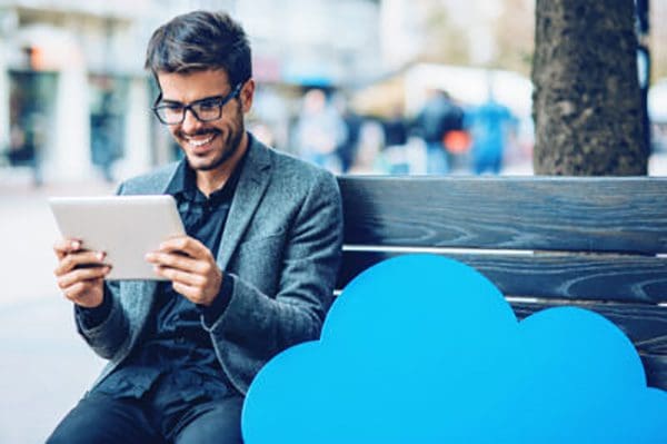 Man holding tablet and smiling