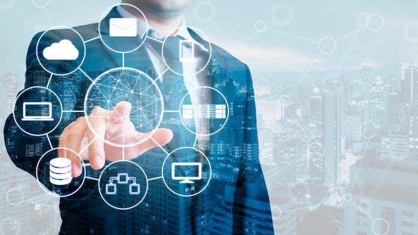 Double exposure of businessman connected devices with internet and wireless network on touch screen and city of business background in business and technology concept