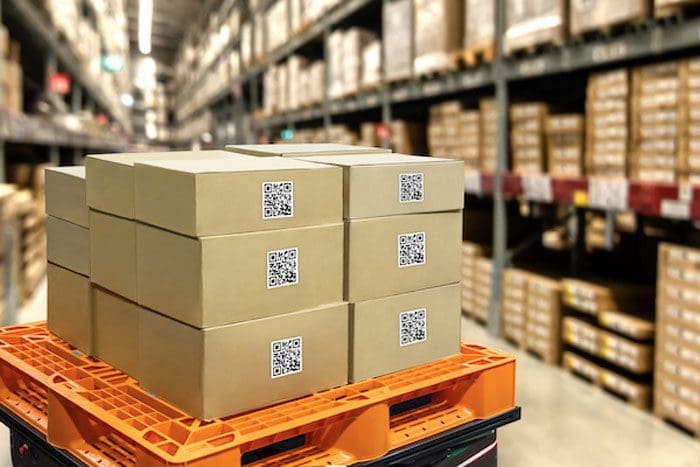 Smart logistic industry 4.0 , QR Codes Asset warehouse and inventory management supply chain technology concept. Group of boxes in storehouse can check product inside and order pick time.