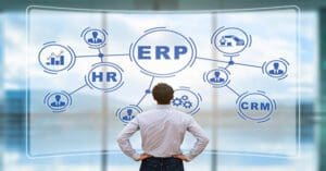 IT manager analyzing the architecture of ERP (Enterprise Resource Planning) system on virtual AR screen with connections between business intelligence (BI), production, HR and CRM modules