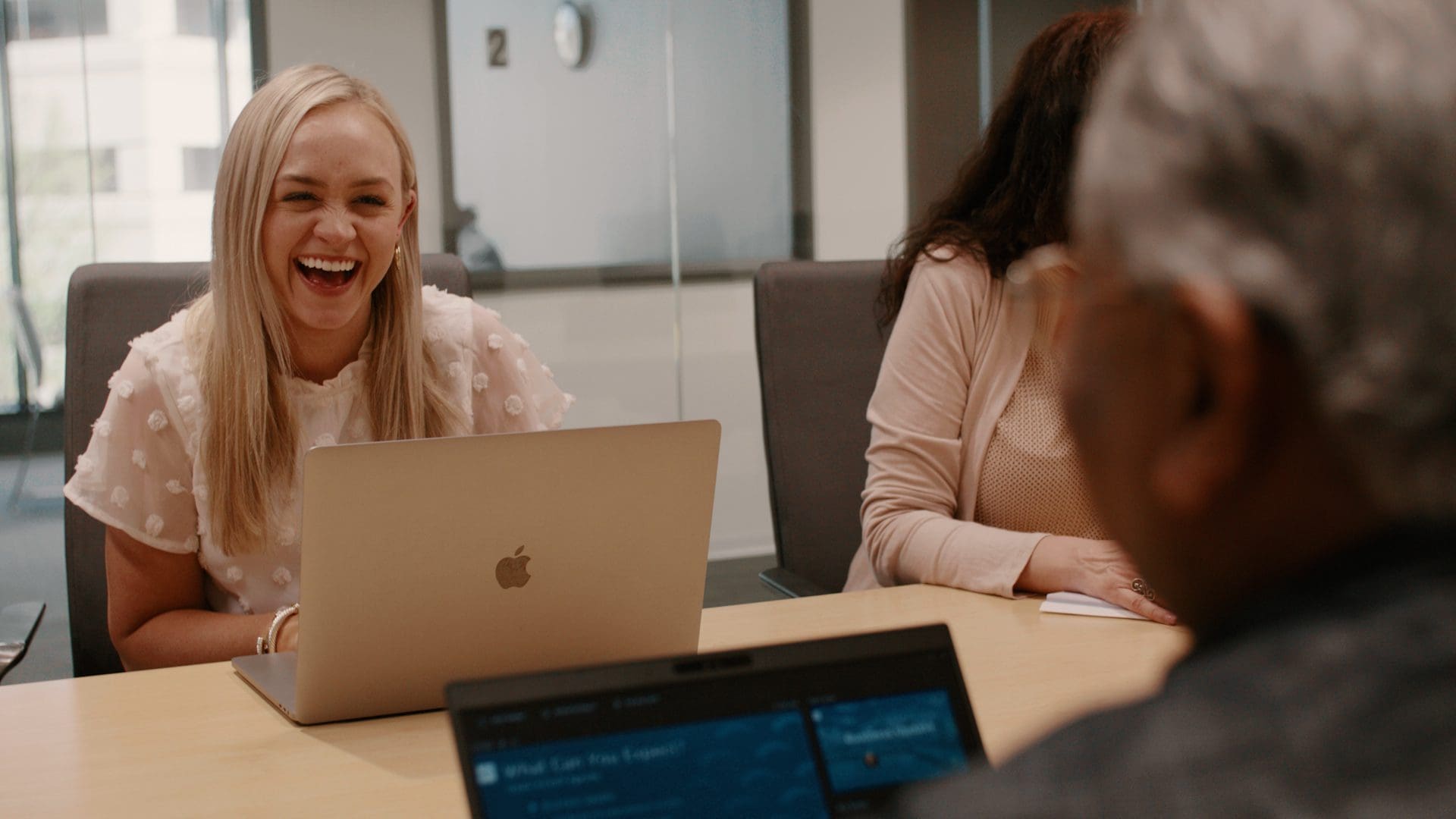Bridgepoint employee laughing during a meeting in the Bridgepoint office