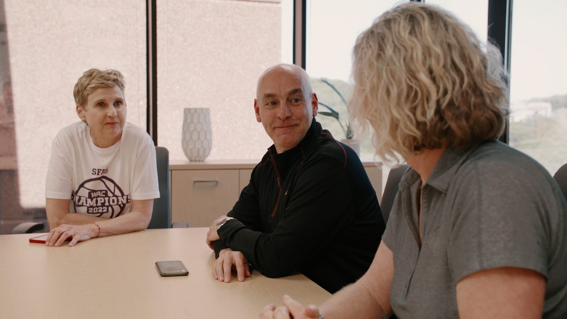Bridgepoint leader listening to a colleague share ideas during a meeting