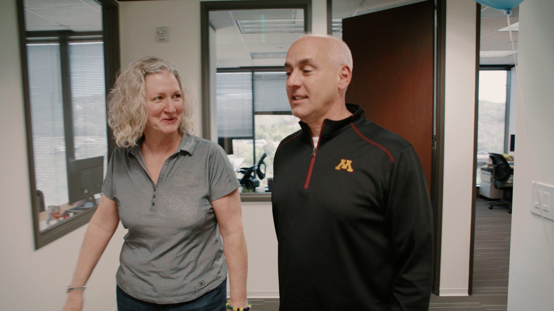 Two Bridgepoint leaders walking and talking in the Bridgepoint office