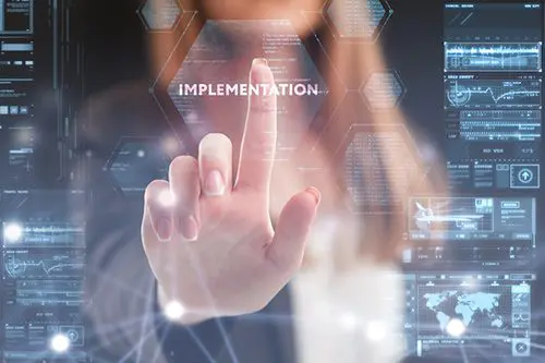 The concept of business, technology, the Internet and the network. A young entrepreneur working on a virtual screen of the future and sees the inscription: Implementation