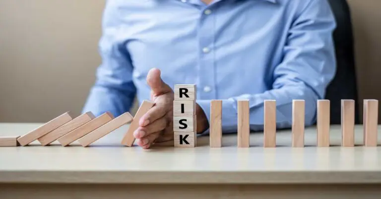 Businessman hand Stopping Falling wooden Blocks or Dominoes. Business, Risk Management, Solution, Insurance and strategy Concepts